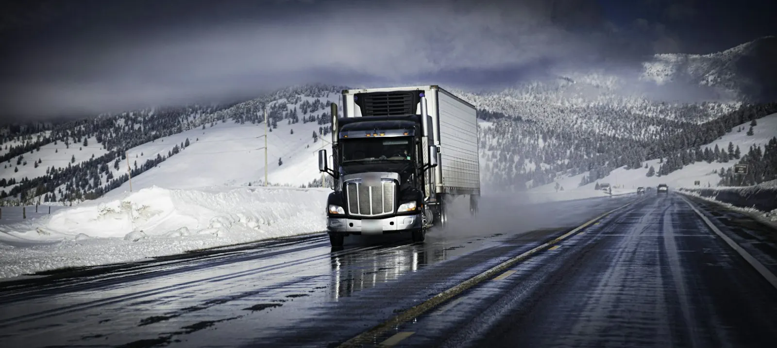 A long-nose semi truck on a snowy highway in Montana
