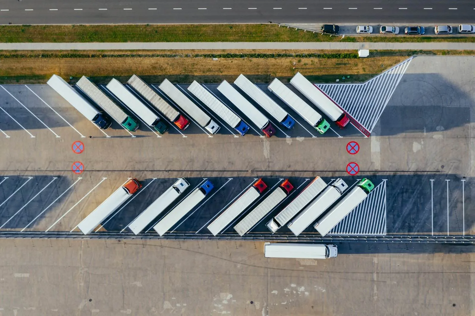 A fleet yard of parked semi trucks, seen from above