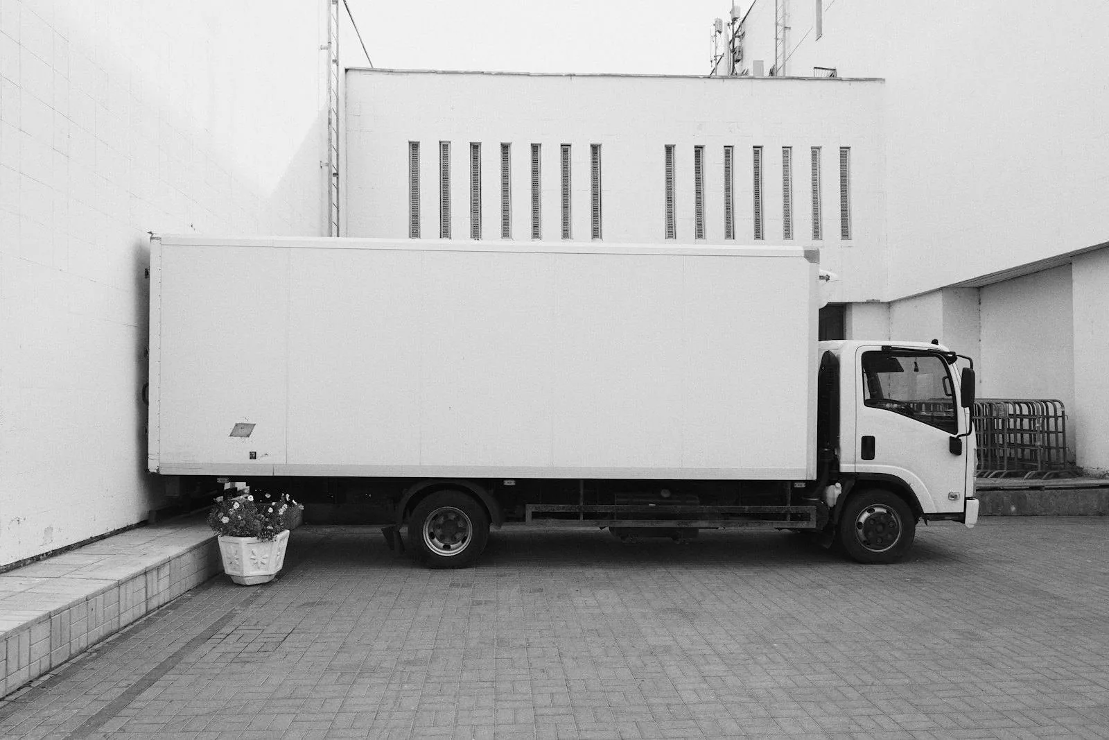 A box truck parked at a building